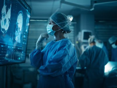 Caucasian,Female,Surgeon,Examines,Detailed,Brain,Scans,On,A,Big